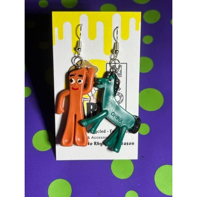 Pair of orange and green earrings on a branded card with a colorful polka dot background.