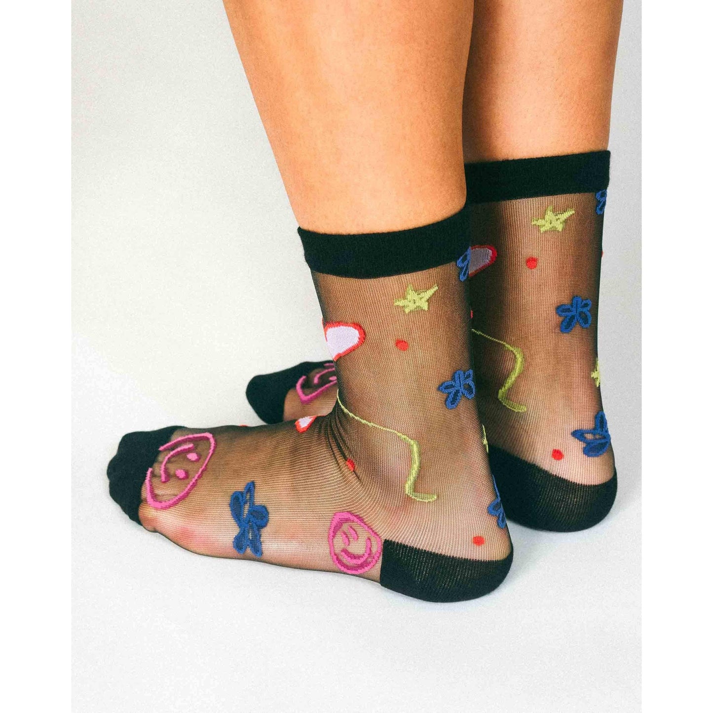 Happy Doodles Sheer Crew Socks by Hannah Packer | Women's Black Lightweight Graphic Socks