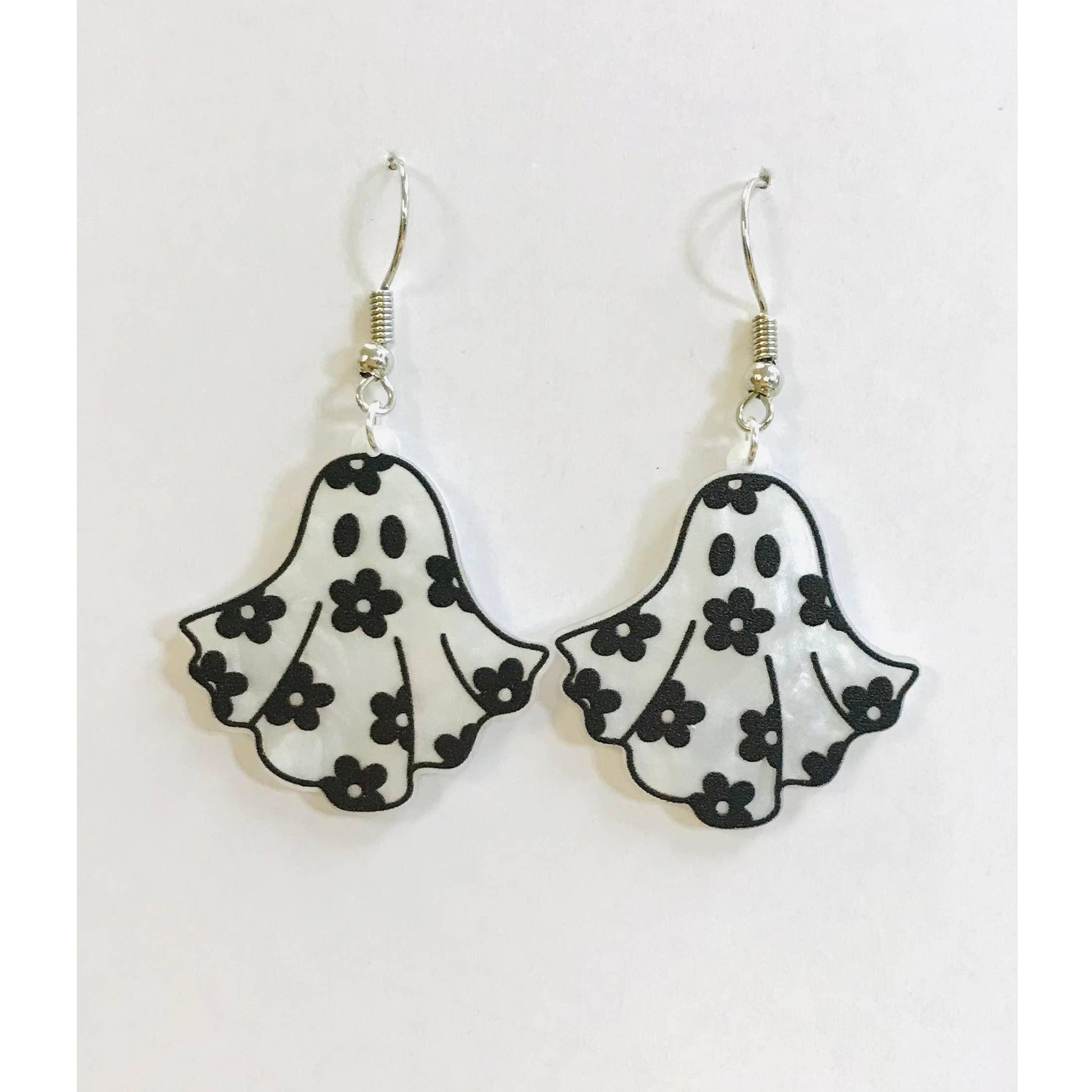 Ghost-shaped earrings with floral patterns on a white background