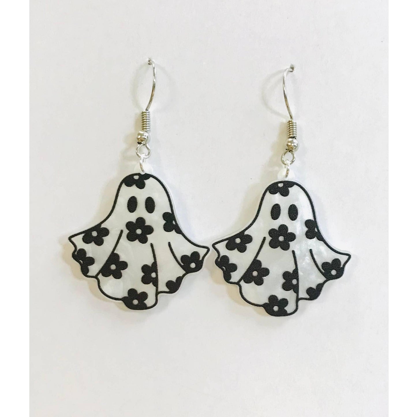 Ghost-shaped earrings with floral patterns on a white background