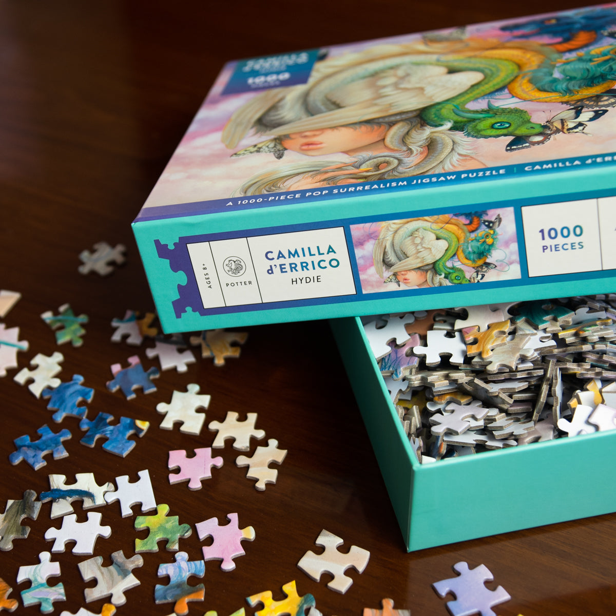 Camilla d'Errico puzzle with pieces scattered on a wooden surface