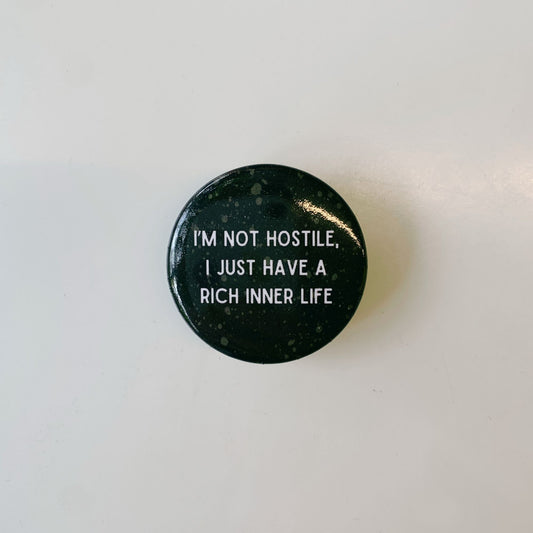 I'm Not Hostile I Just Have a Rich Inner Life 1.5" Button in Black and Tan