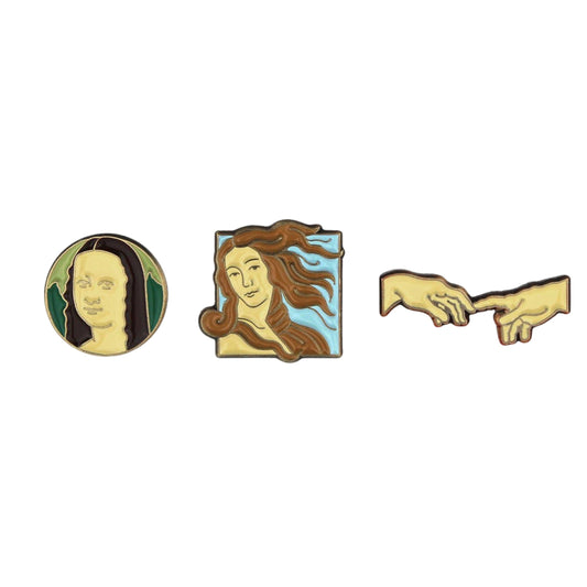 Three pins featuring artistic depictions on a white background