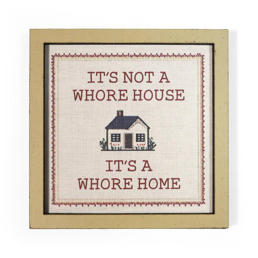 Decorative magnet with text 'It's not a whore house, it's a whore home' and a small house illustration.