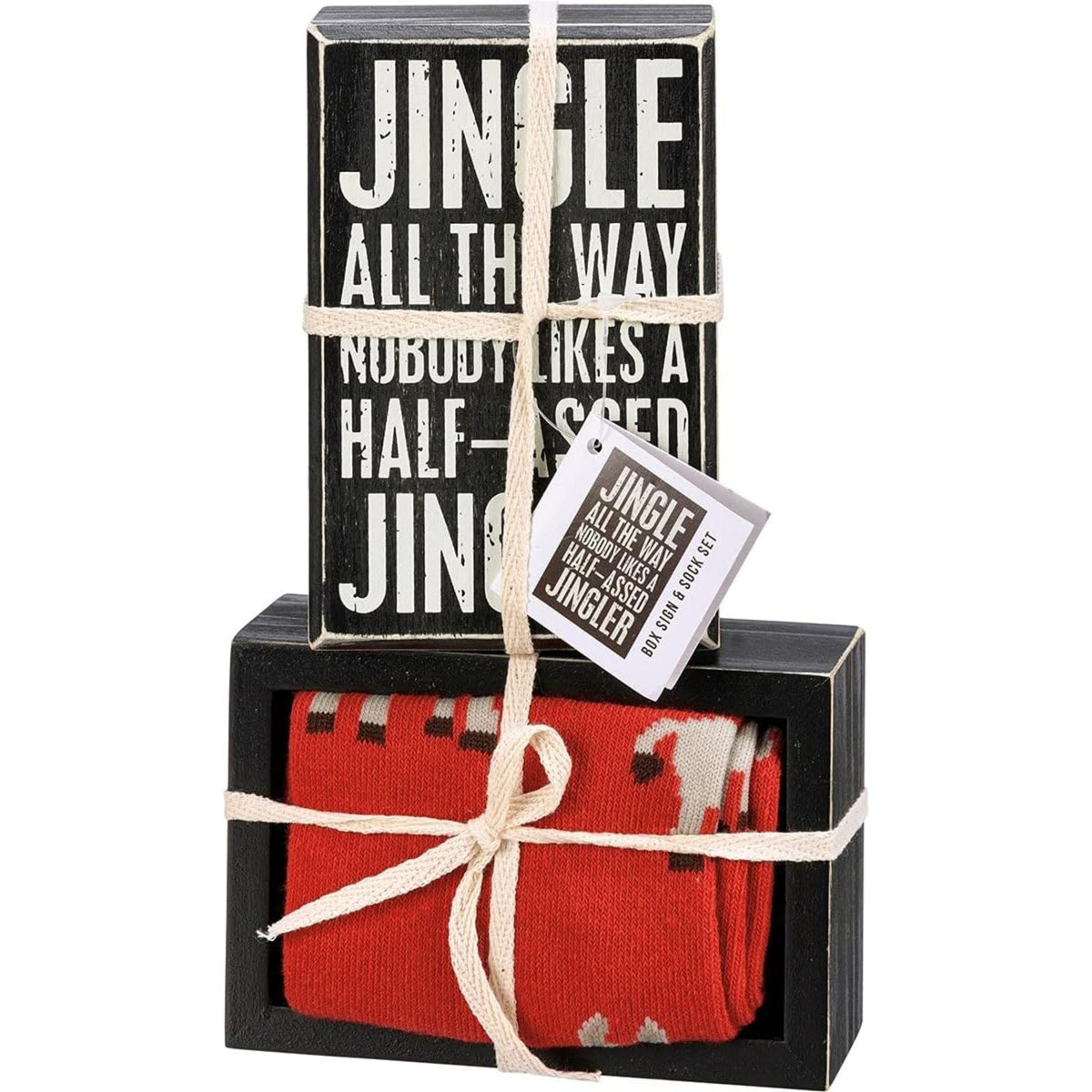 Boxed set with red socks and a small sign with Jingle All The Way Nobody Like a Half-assed Jingler text, tied together.