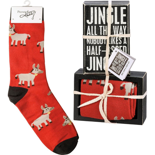 Red socks with donkey pattern and 'Jingle All the Way' wooden box sign