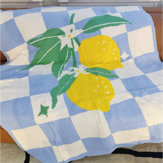 Throw blanket with lemon design on a blue and white checkered background