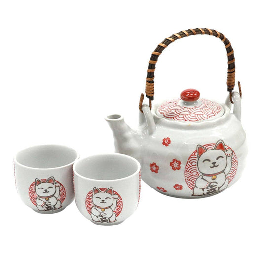 White ceramic teapot and two cups with red cat illustrations 