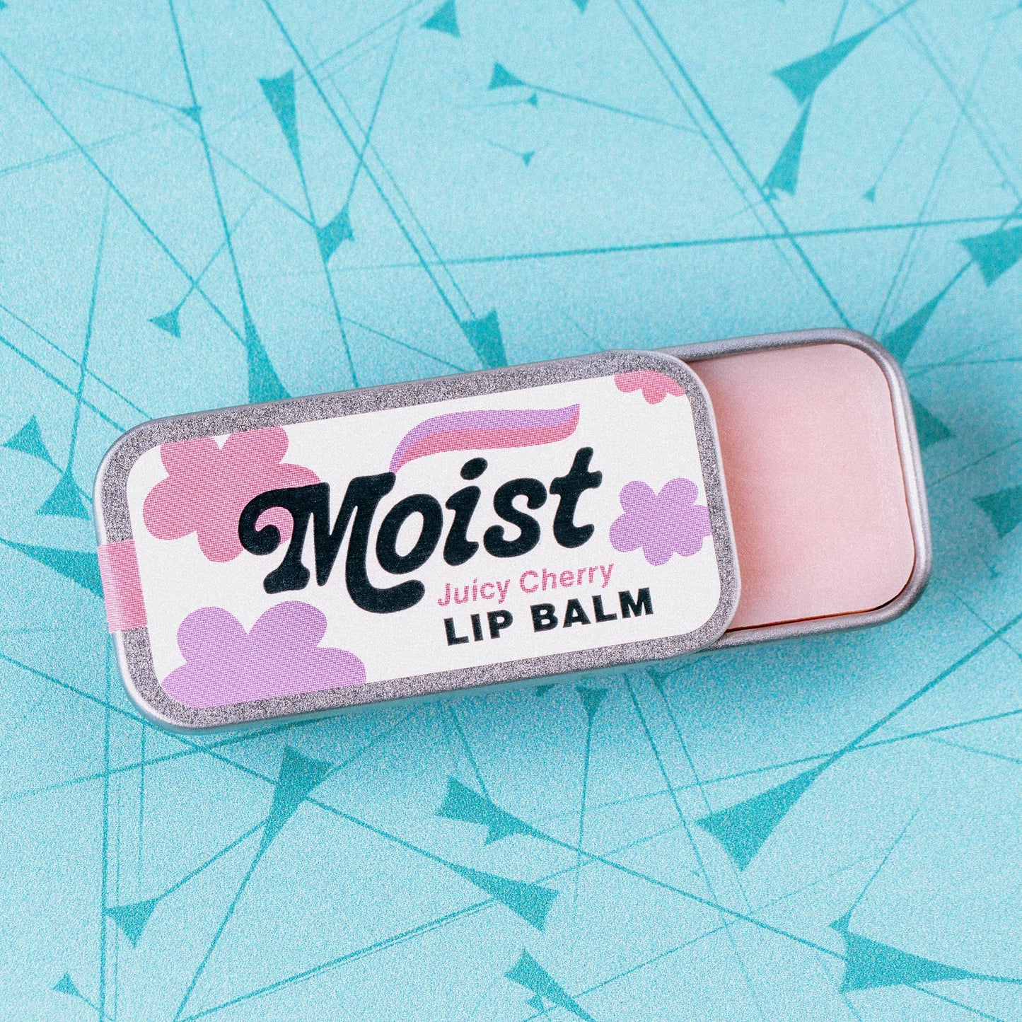 Lip balm container labeled 'Moist Juicy Cherry' 