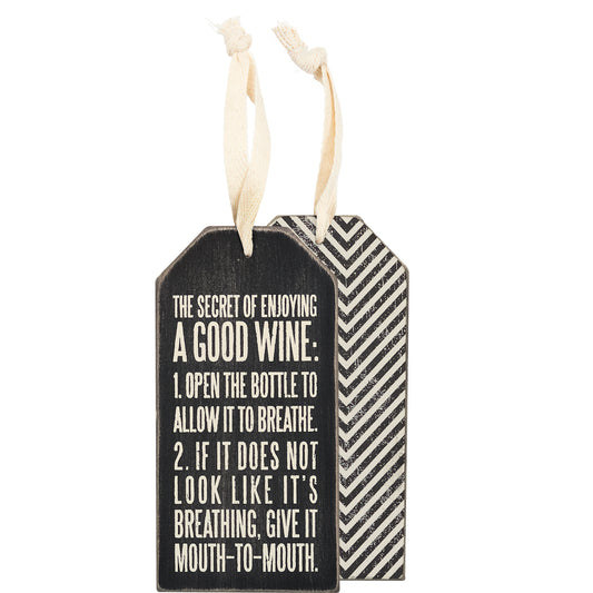Decorative bottle tag with wine advice text on a white background