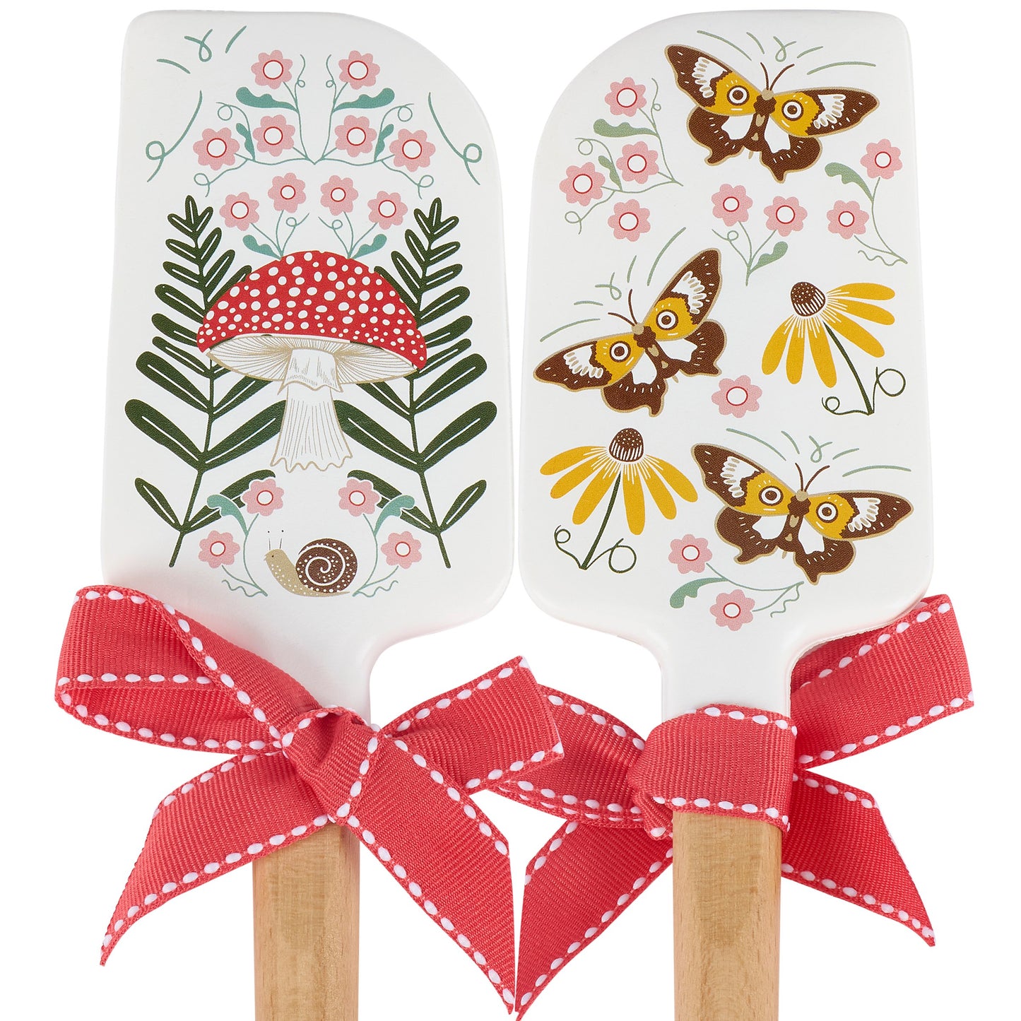 Two spatulas with floral, mushroom and nature-themed designs on a white background