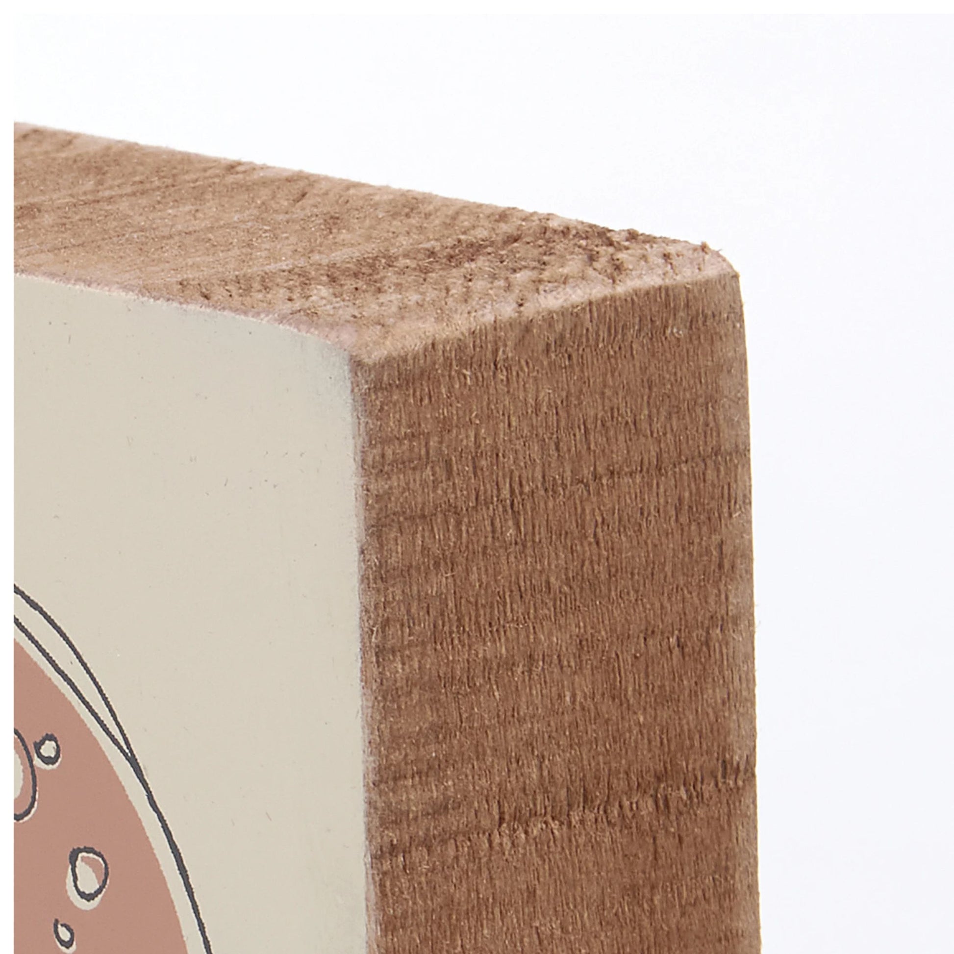 Close-up of a wooden block with a white and brown design