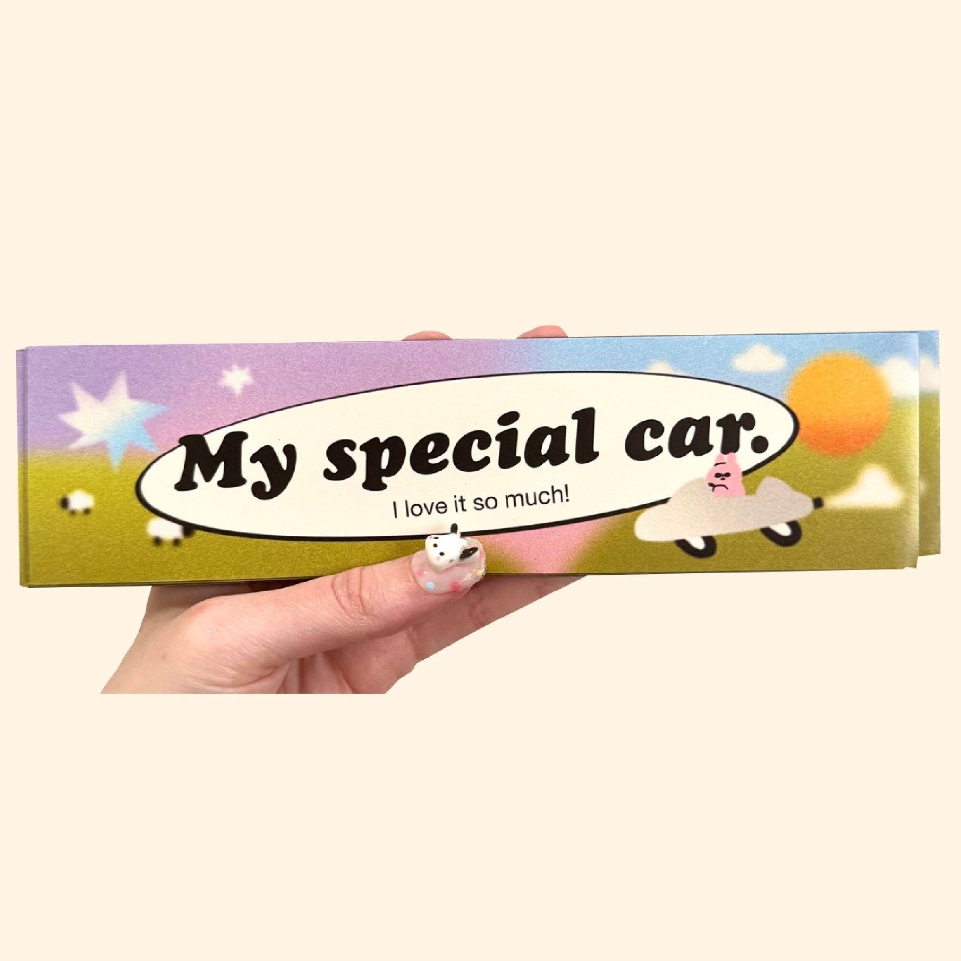 Cartoon-style box with 'My special car' text and a cartoon character in a car, held by a hand.