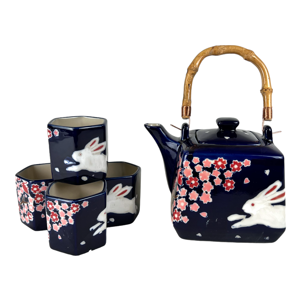 Navy blue ceramic teapot set with white rabbit and pink floral design 