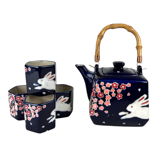 Navy blue ceramic teapot set with white rabbit and pink floral design 