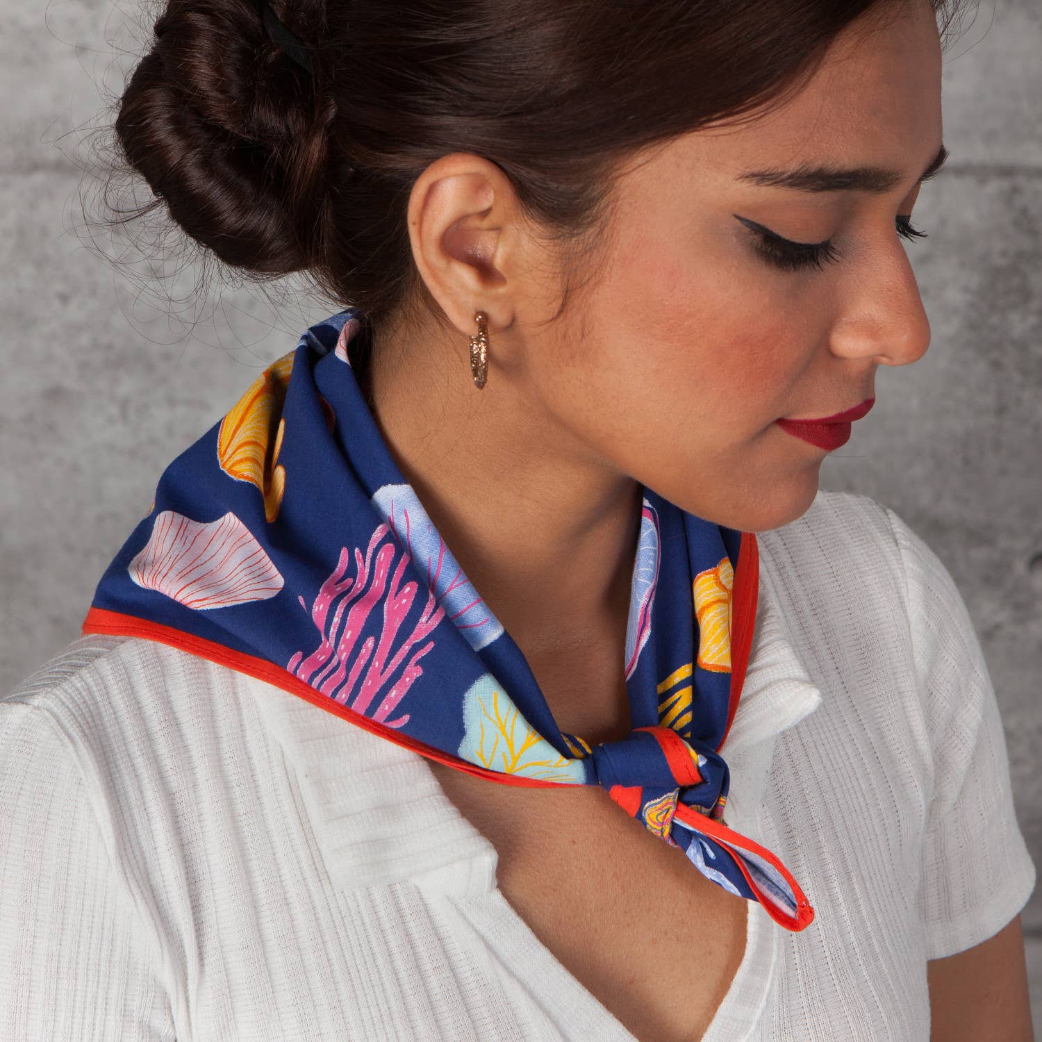 Woman wearing a colorful scarf around her neck 
