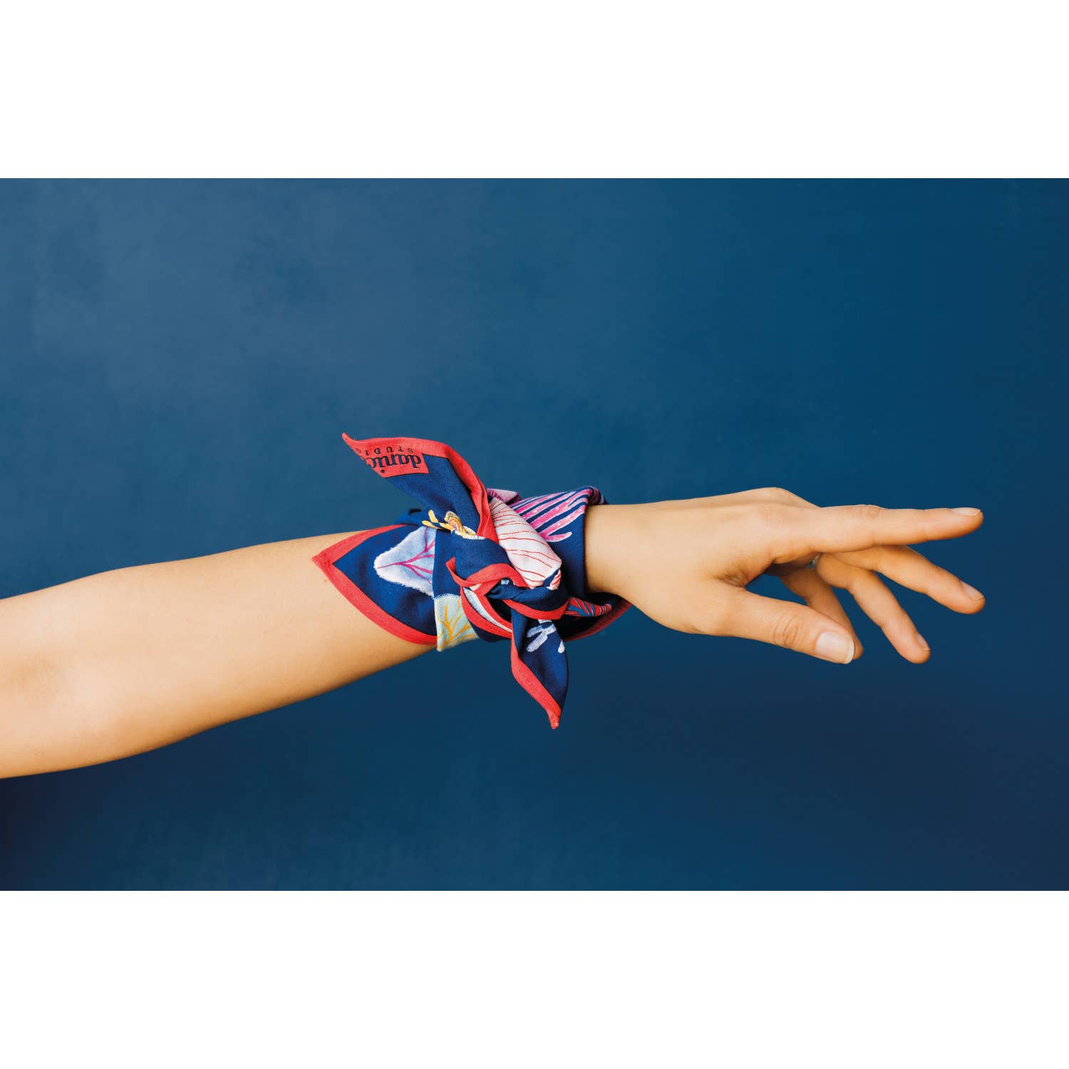 Hand wearing a colorful bandana
