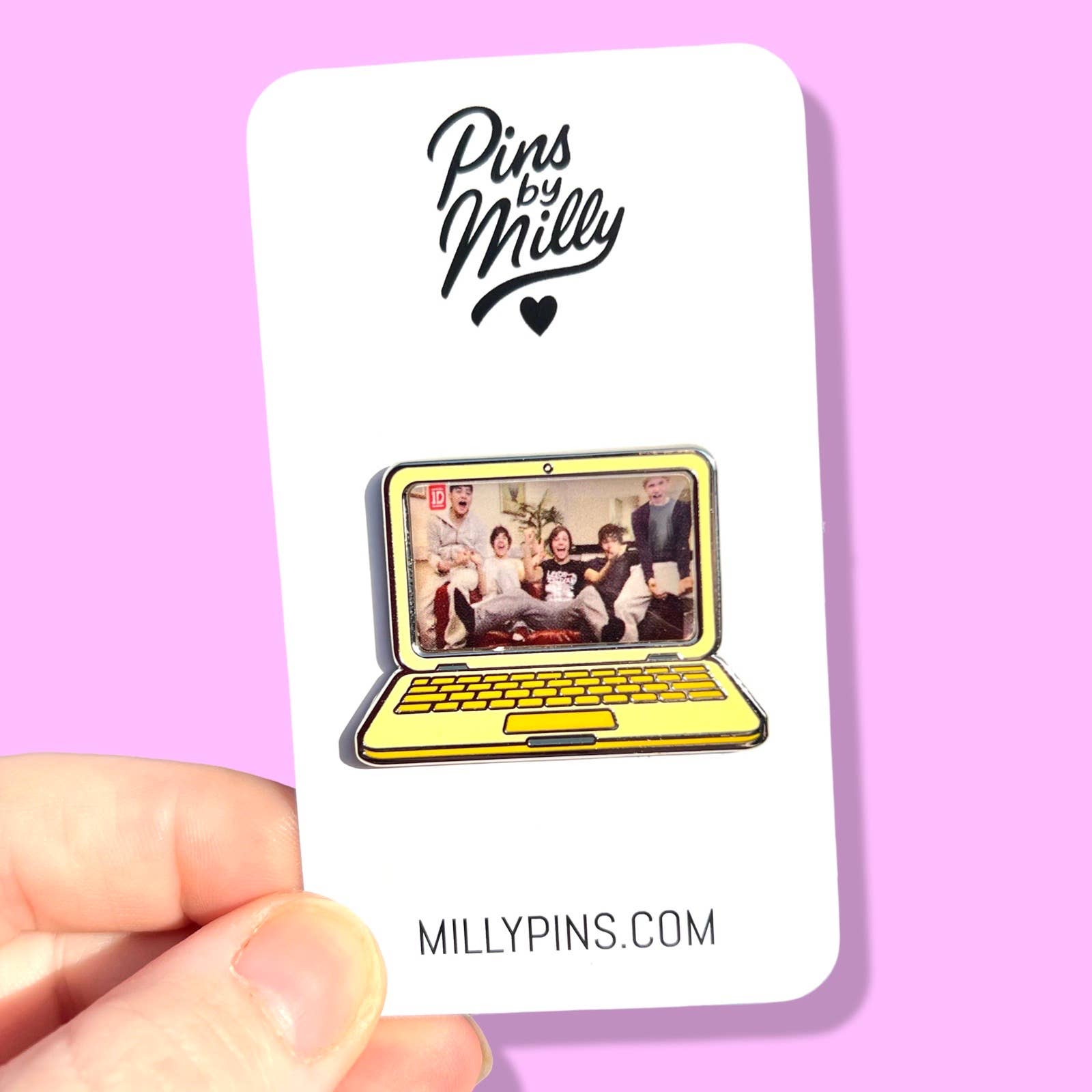 Pin of a laptop with a screen showing One Direction, on a card with 'Pins by Milly' branding, against a pink background.