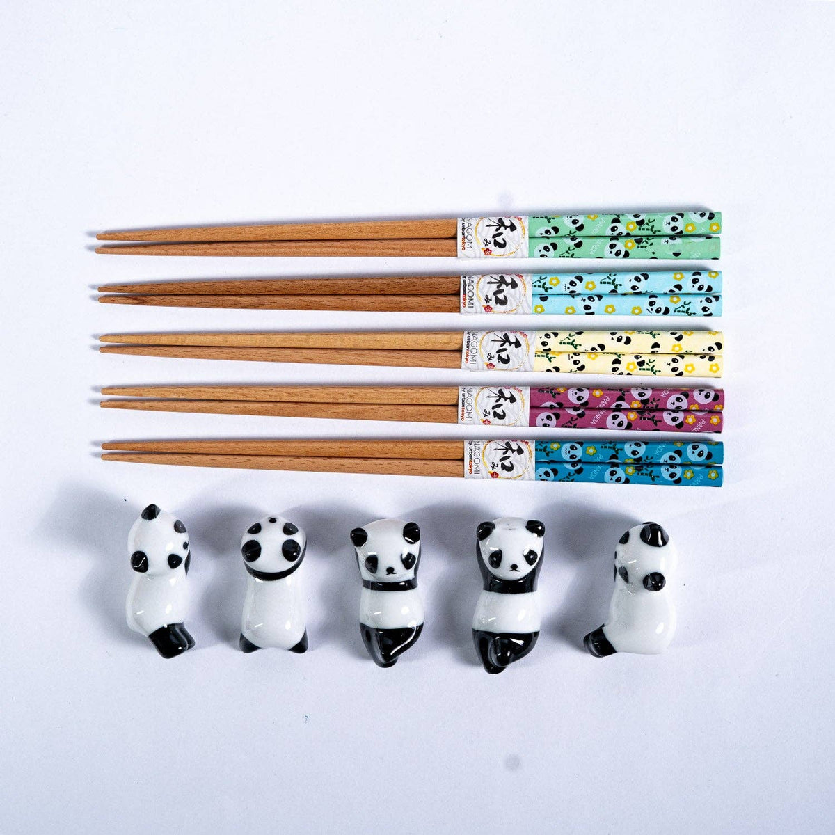 Set of panda-shaped chopstick rests with five pairs of wooden chopsticks.