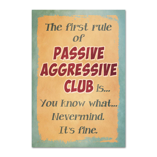 A rectangular magnet with a distressed design featuring the text 'The first rule of PASSIVE AGGRESSIVE CLUB is...You know what...Nevermind. It's fine.'