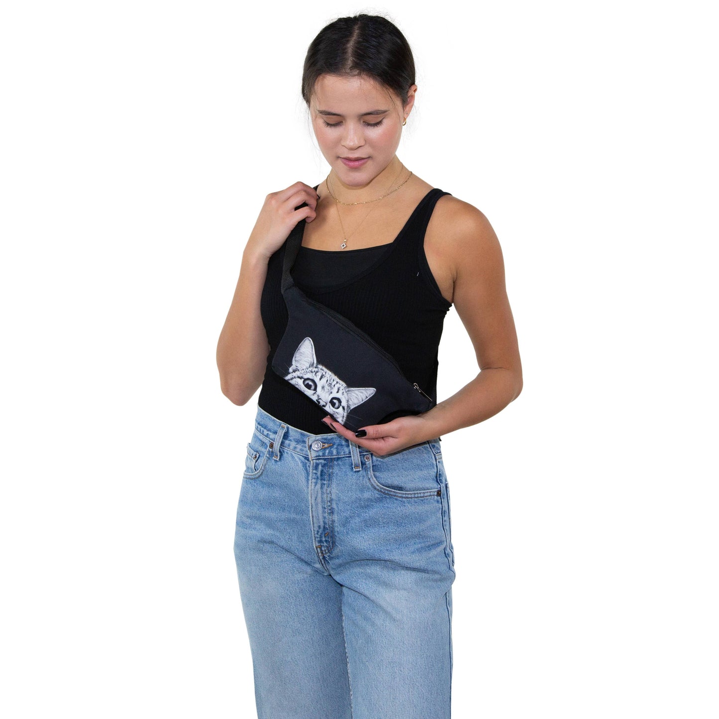 Woman holding a black bag with a cat design on a white background