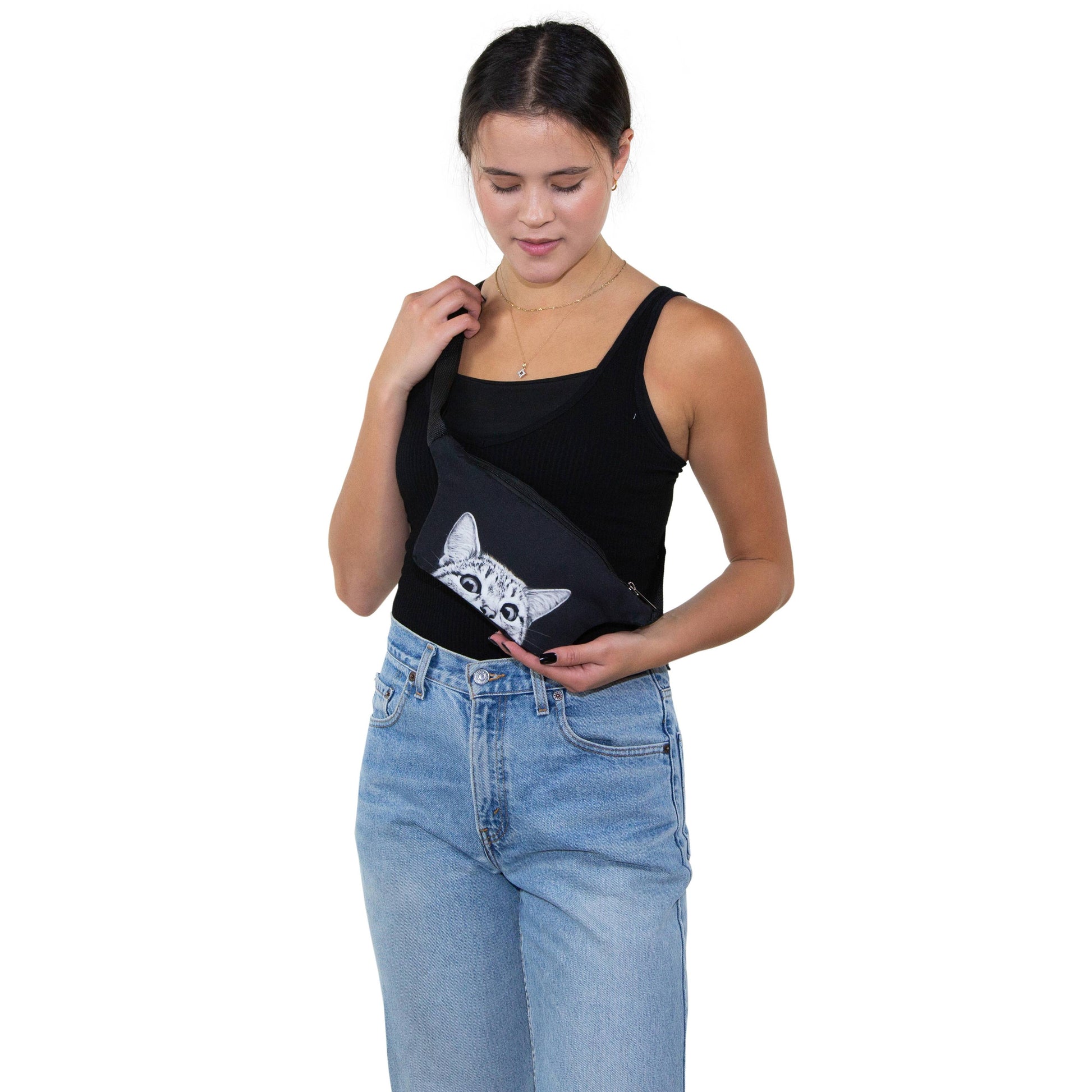 Woman holding a black bag with a cat design on a white background