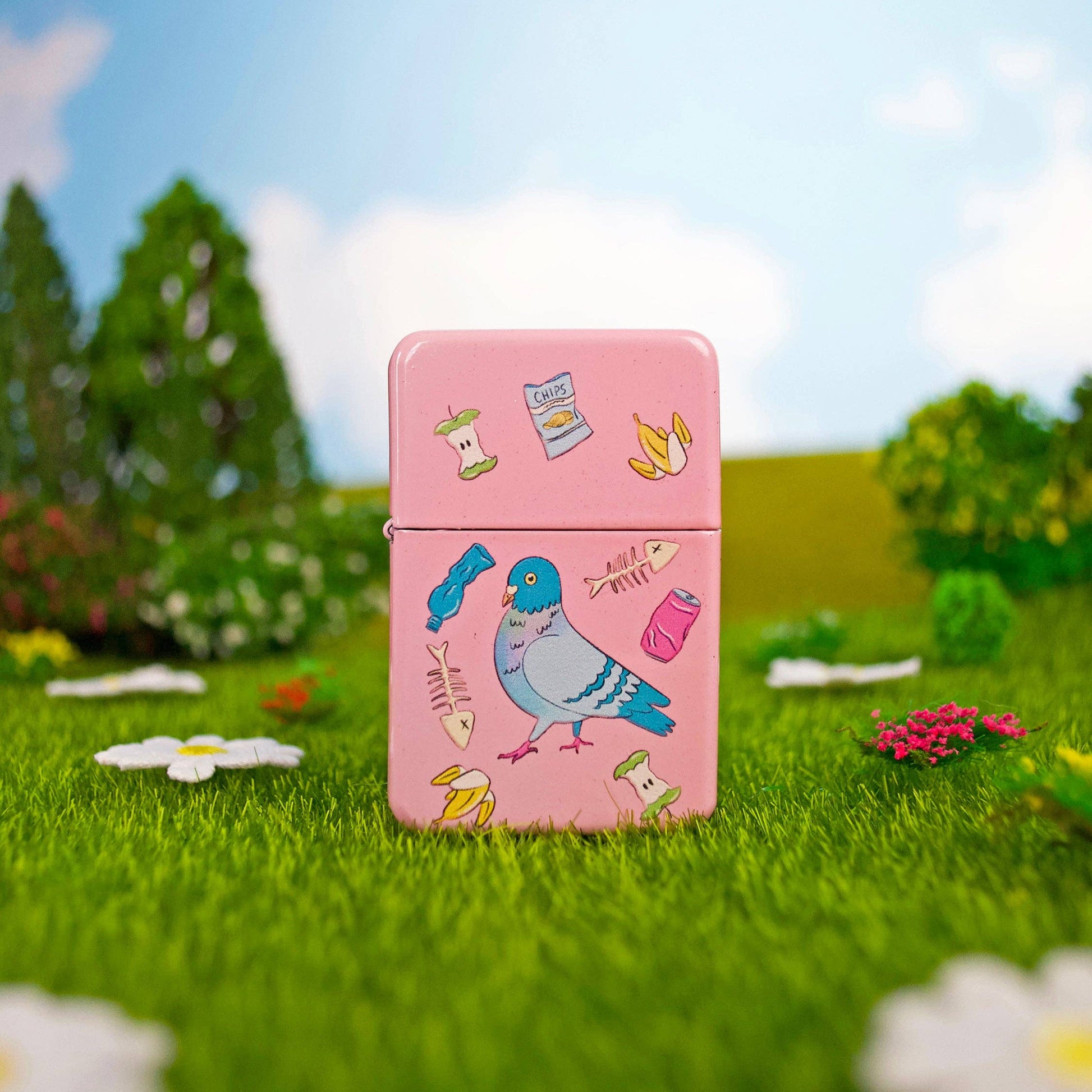 Pink lighter with bird design on grass and flowers