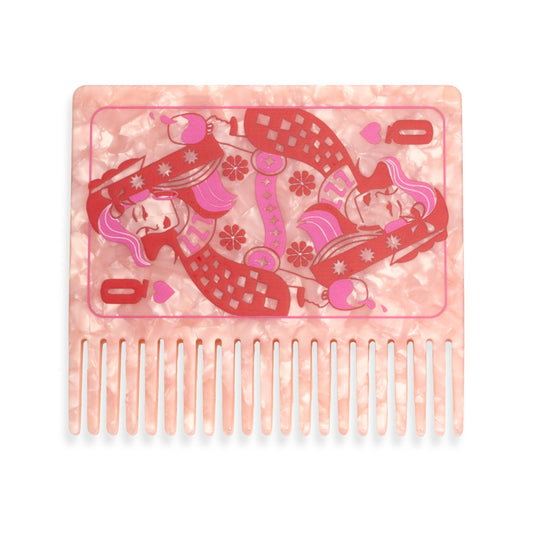 A square hair comb with a translucent pink and white marbled base, featuring a red and pink illustration of queen playing cards
