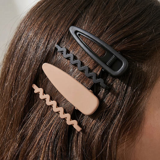 Black and beige hair clips on brown hair