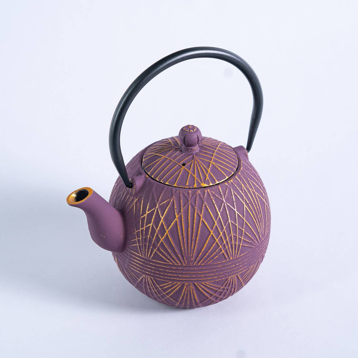 Purple cast iron teapot with gold patterns 