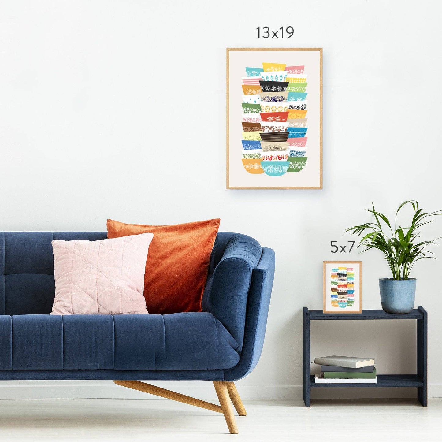 Living room with a blue sofa, colorful pillows, and wall art.