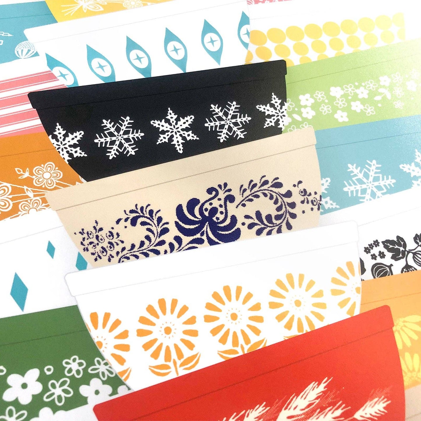 Collection of colorful mixing bowls art print with various patterns on a white background