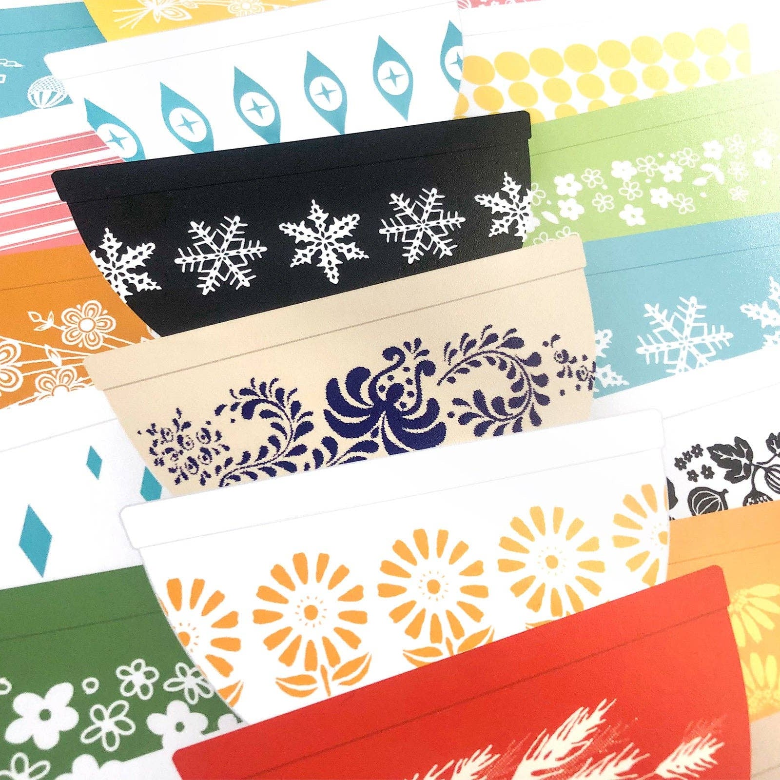 Collection of colorful mixing bowls art print with various patterns on a white background