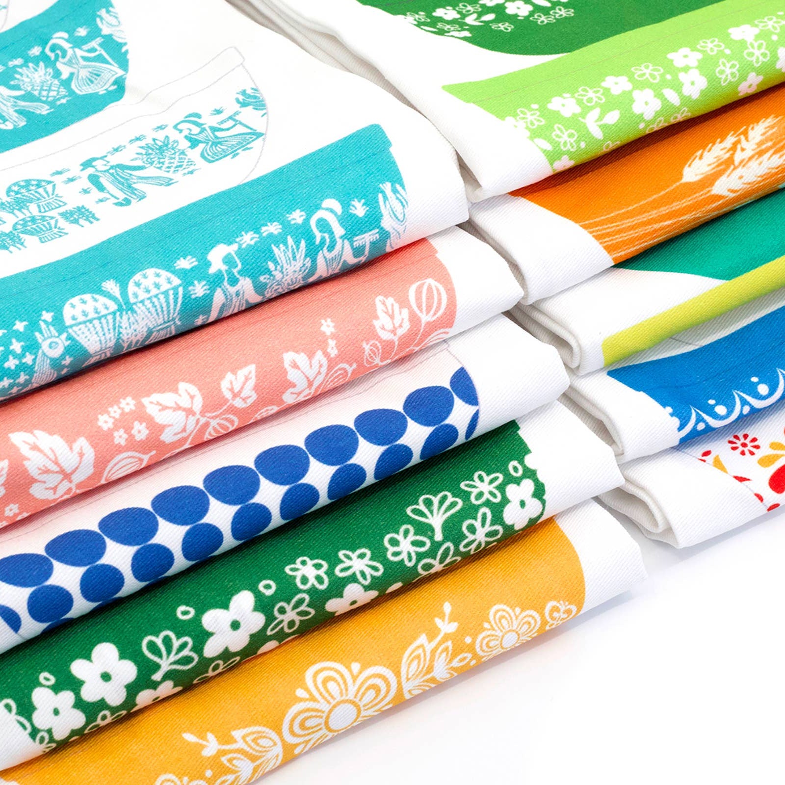 Set of colorful kitchen towels with various patterns on a white background