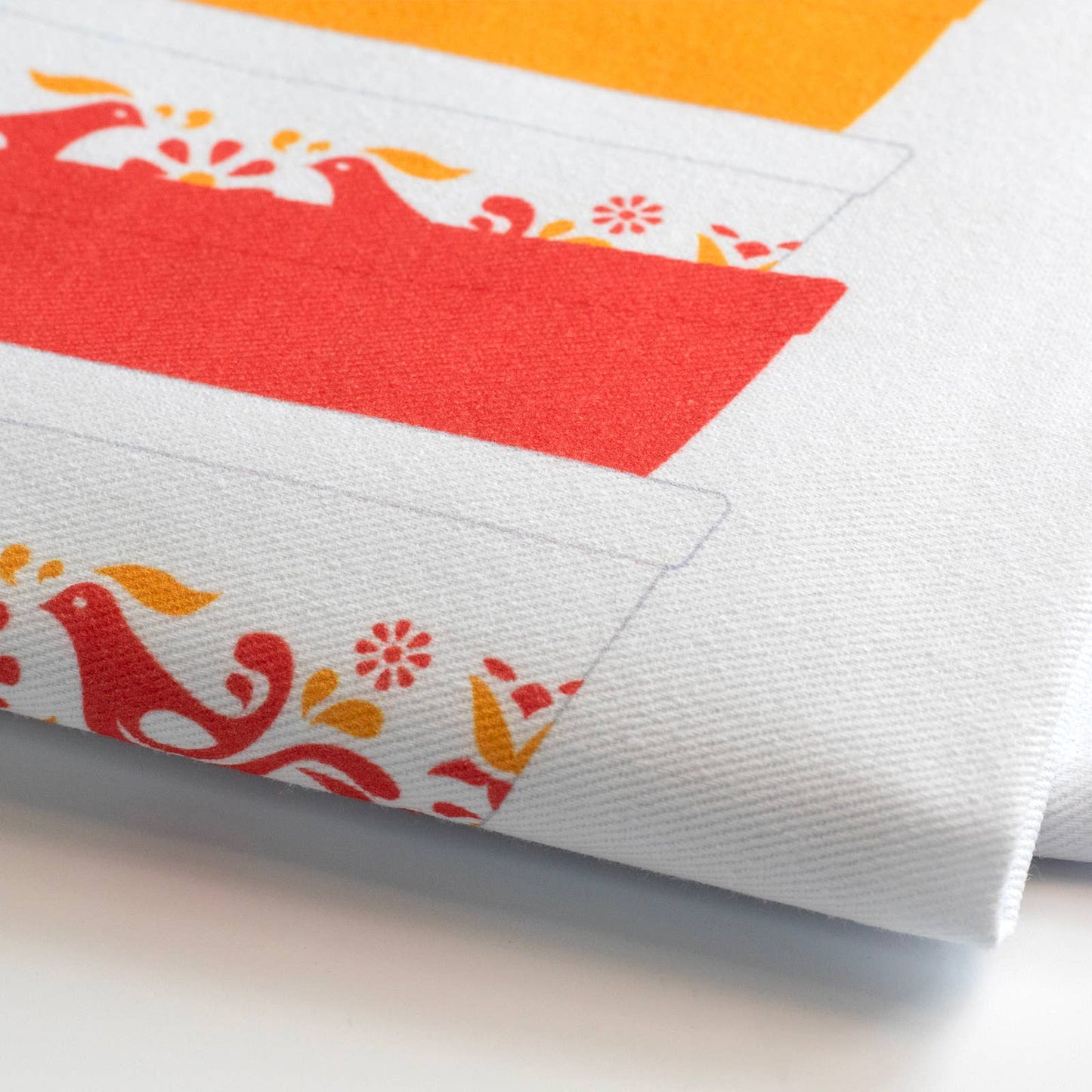 Close-up of a tea towel with colorful patterns on a white background