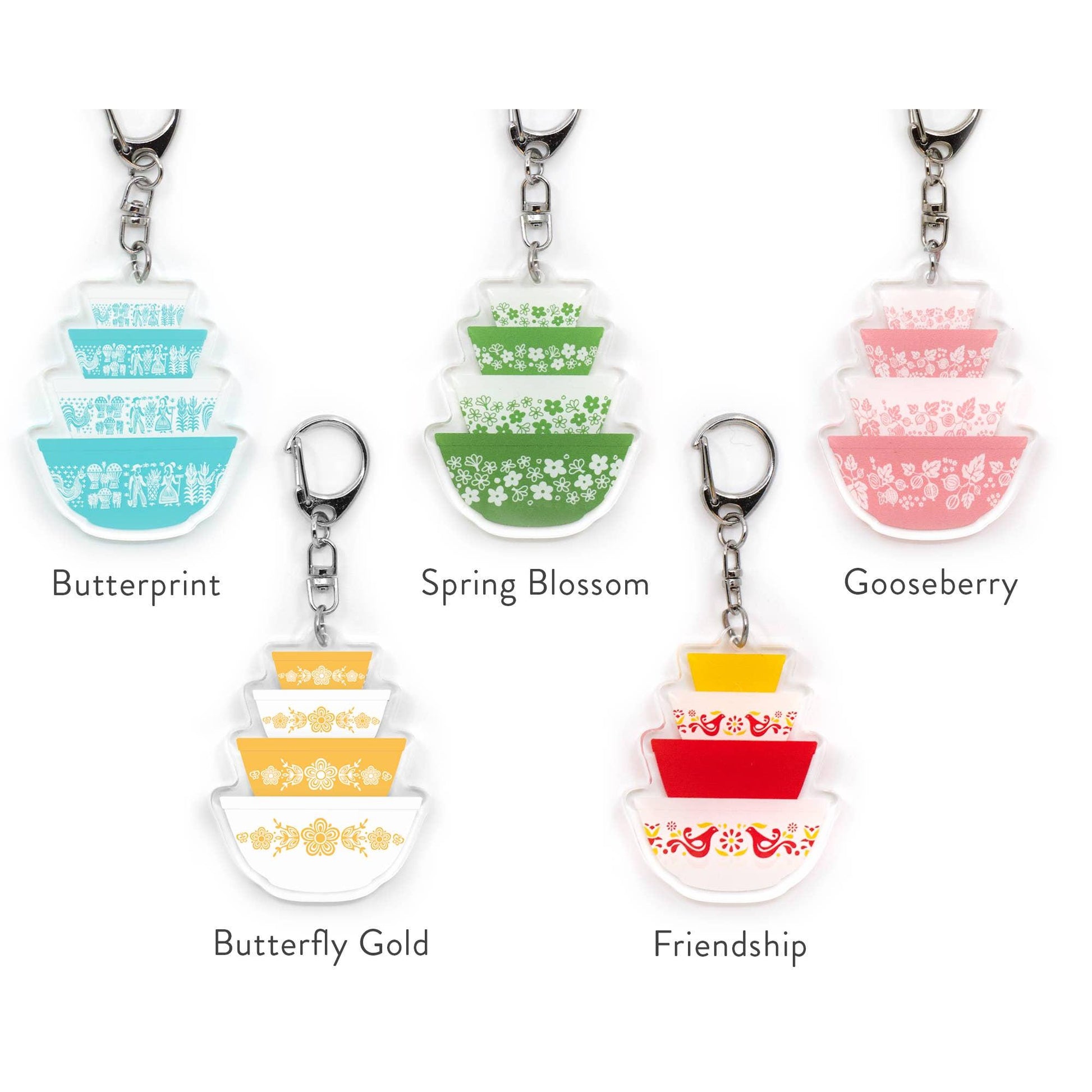 Set of colorful keychains with different patterns and names on a white background