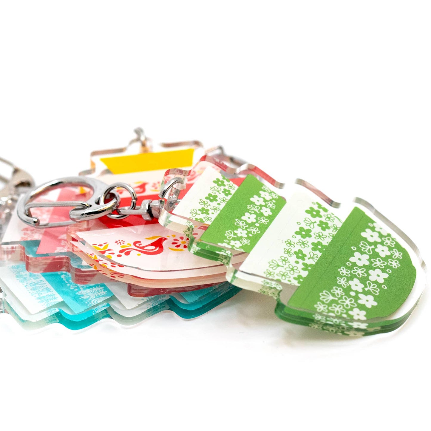 Collection of Pyrex-inspired colorful keychains with floral designs on a white background