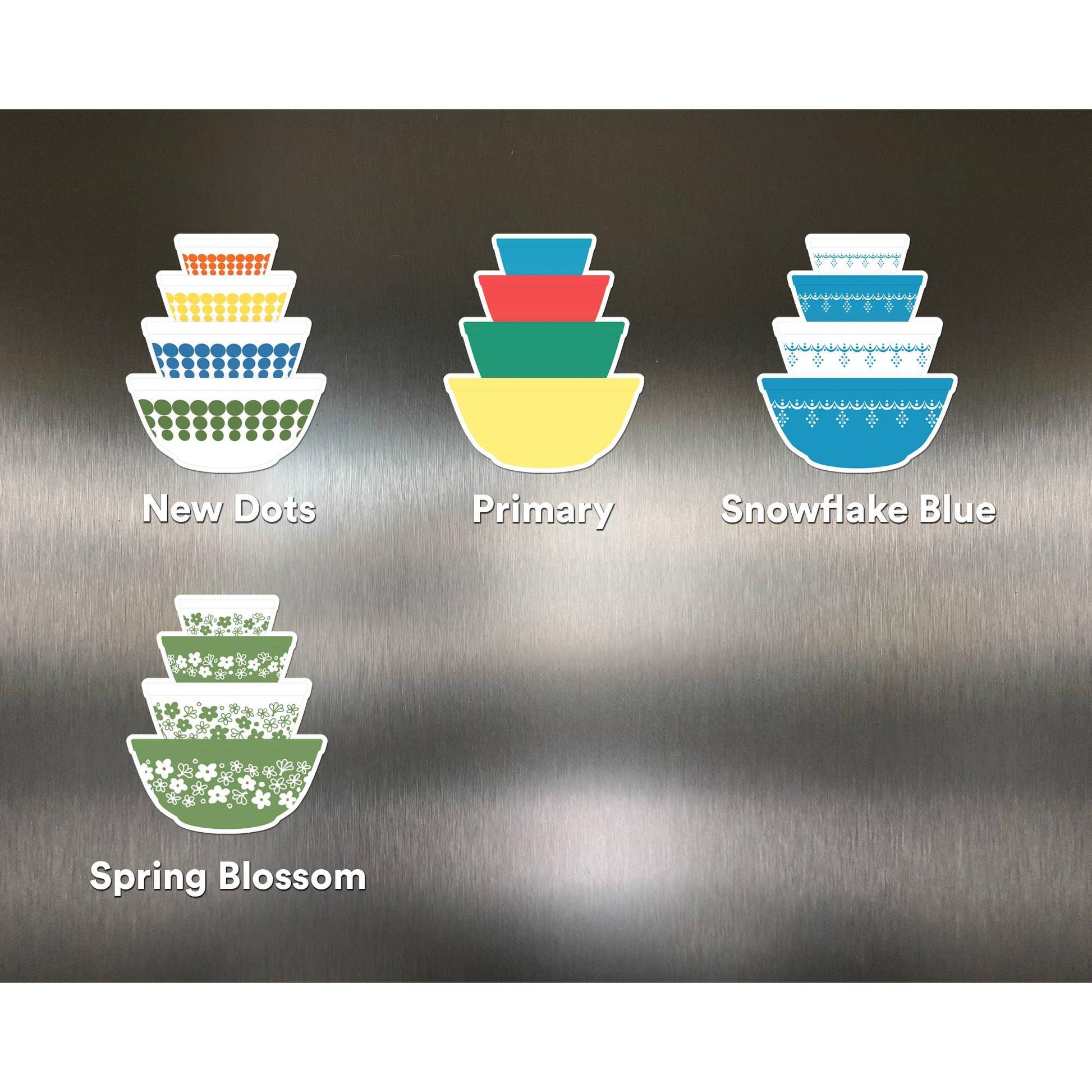 Set of colorful bowls magnet with different patterns on a metallic surface