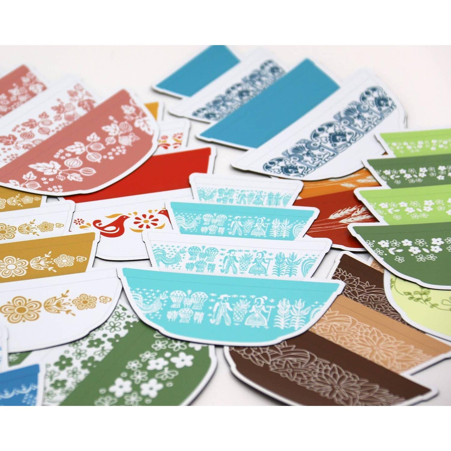 Collection of colorful patterned Pyrex-inspired bowls magnet on a white background