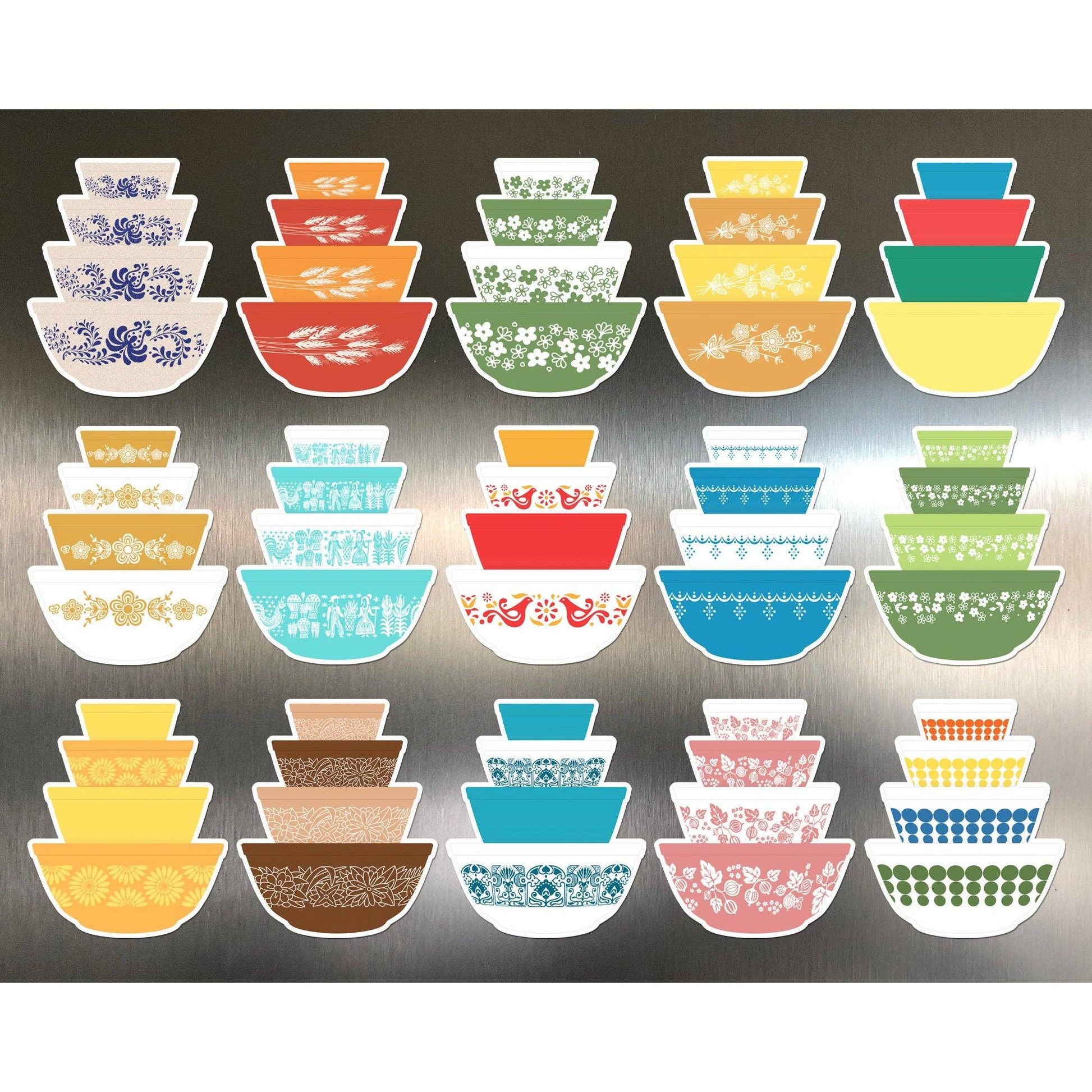 Set of colorful patterned magnetic bowls arranged in rows on a metallic surface.