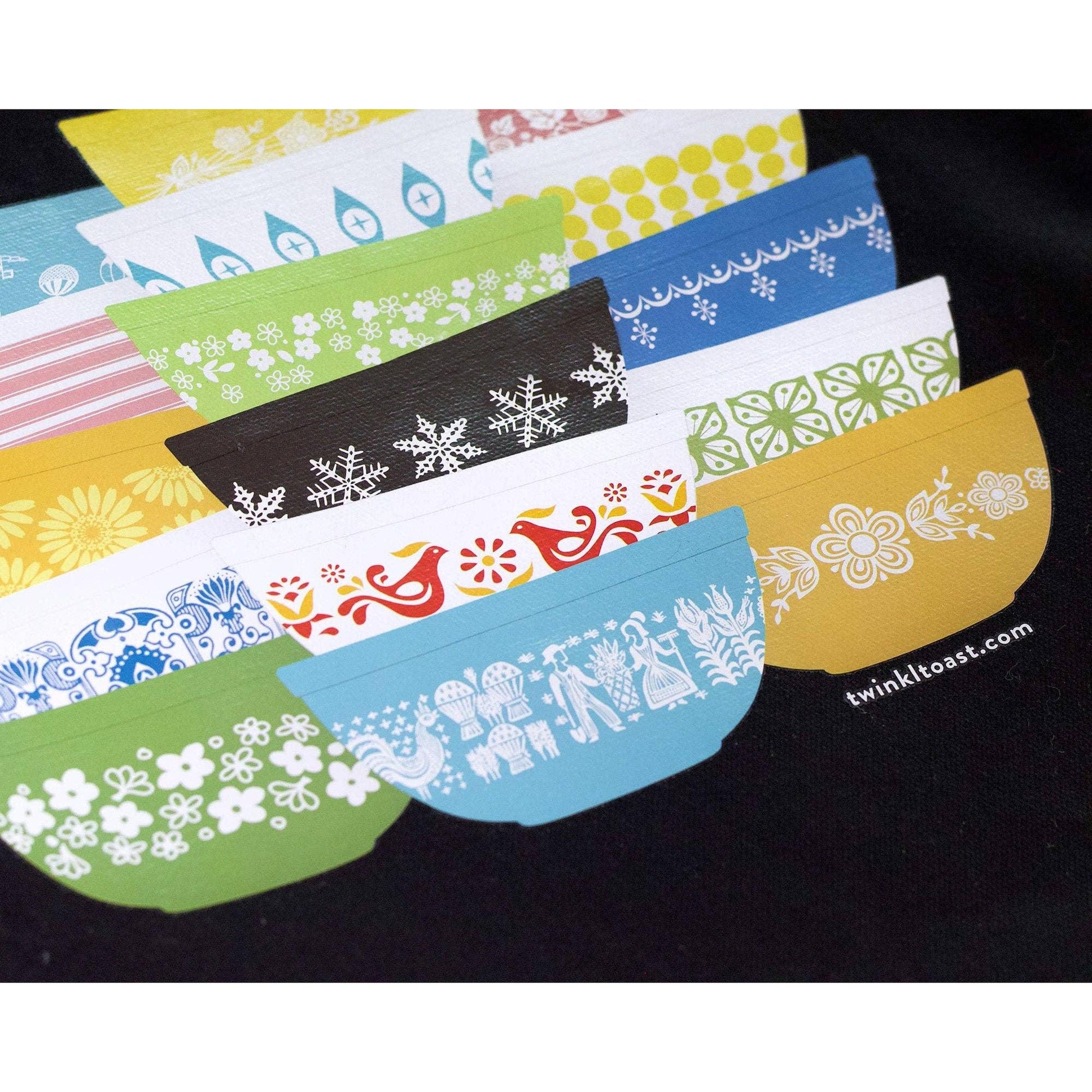 Closeup image of black tote bag with colorful Pyrex-inspired bowl design
