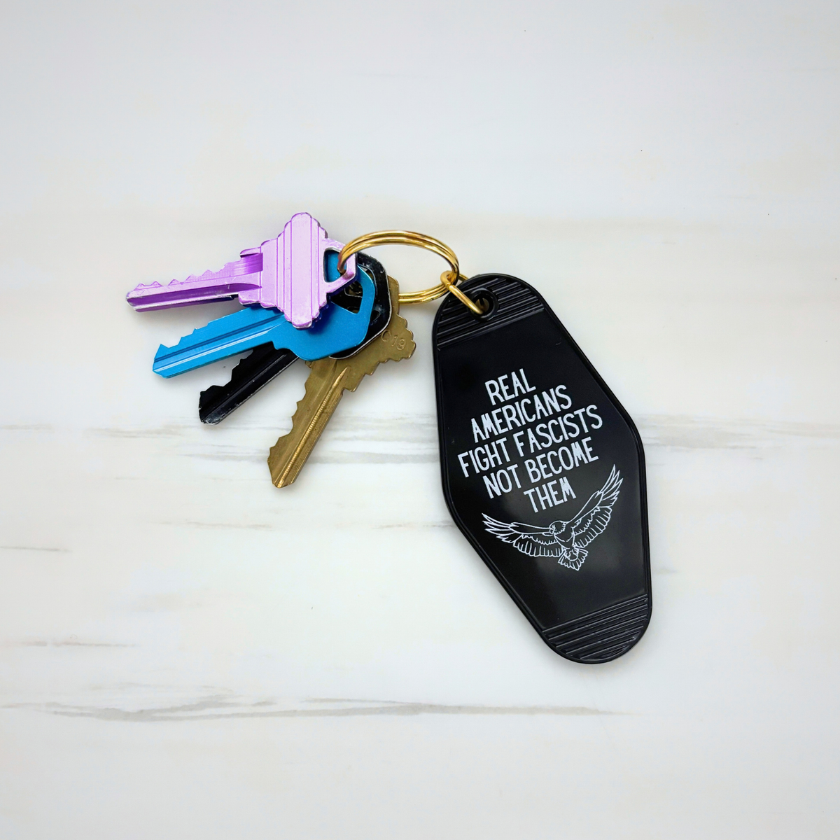 Real Americans Fight Fascists Not Become Them Motel Style Keychain in Black-GetBullish-The Bullish Store