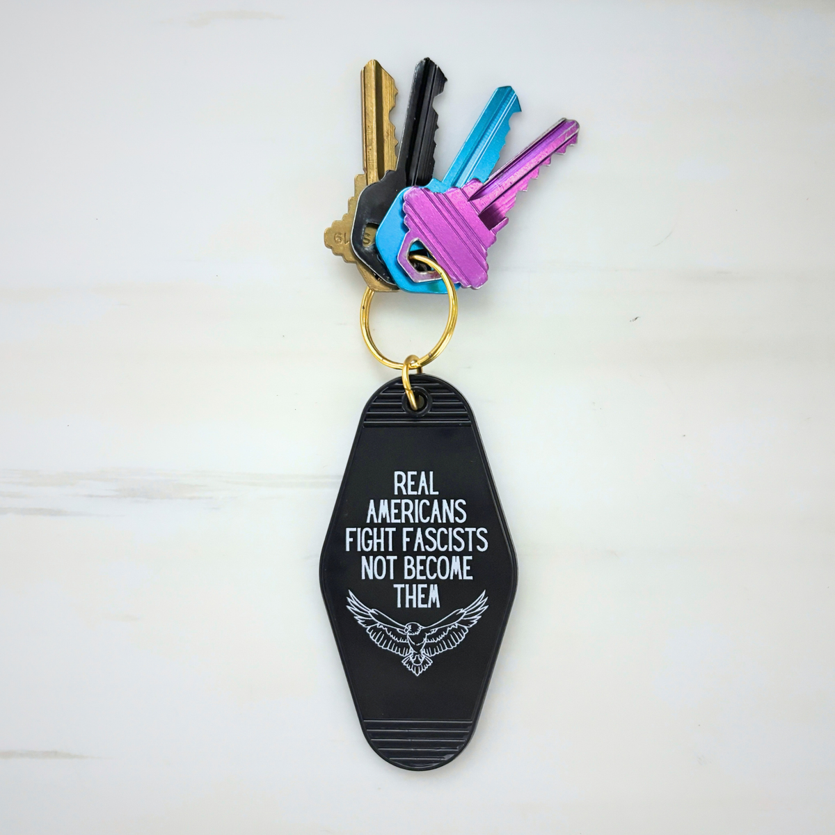 Real Americans Fight Fascists Not Become Them Motel Style Keychain in Black-GetBullish-The Bullish Store