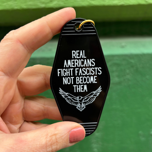 Real Americans Fight Fascists Not Become Them Motel Style Keychain in Black-GetBullish-The Bullish Store