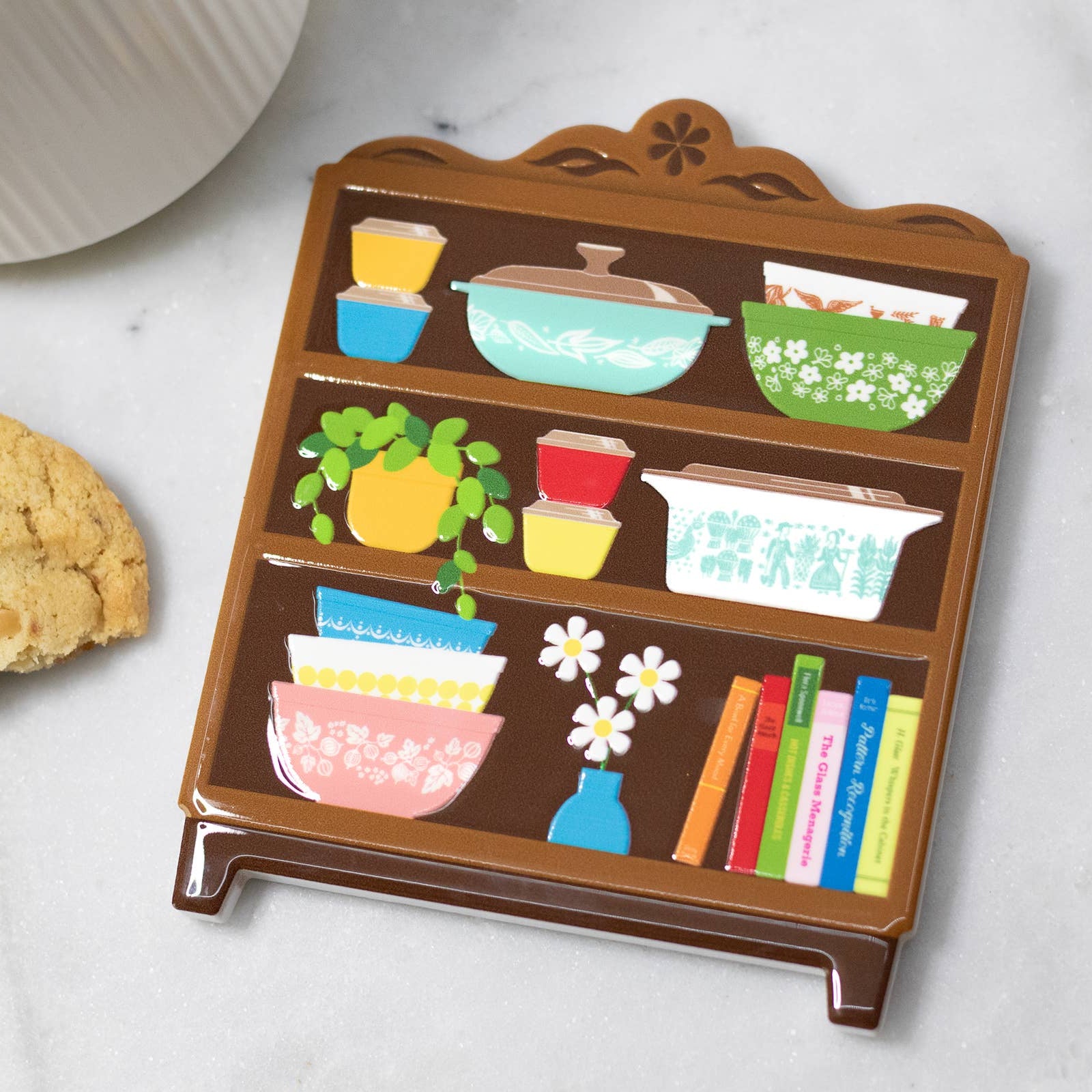Decorative shelf coaster with colorful illustrations on a white surface