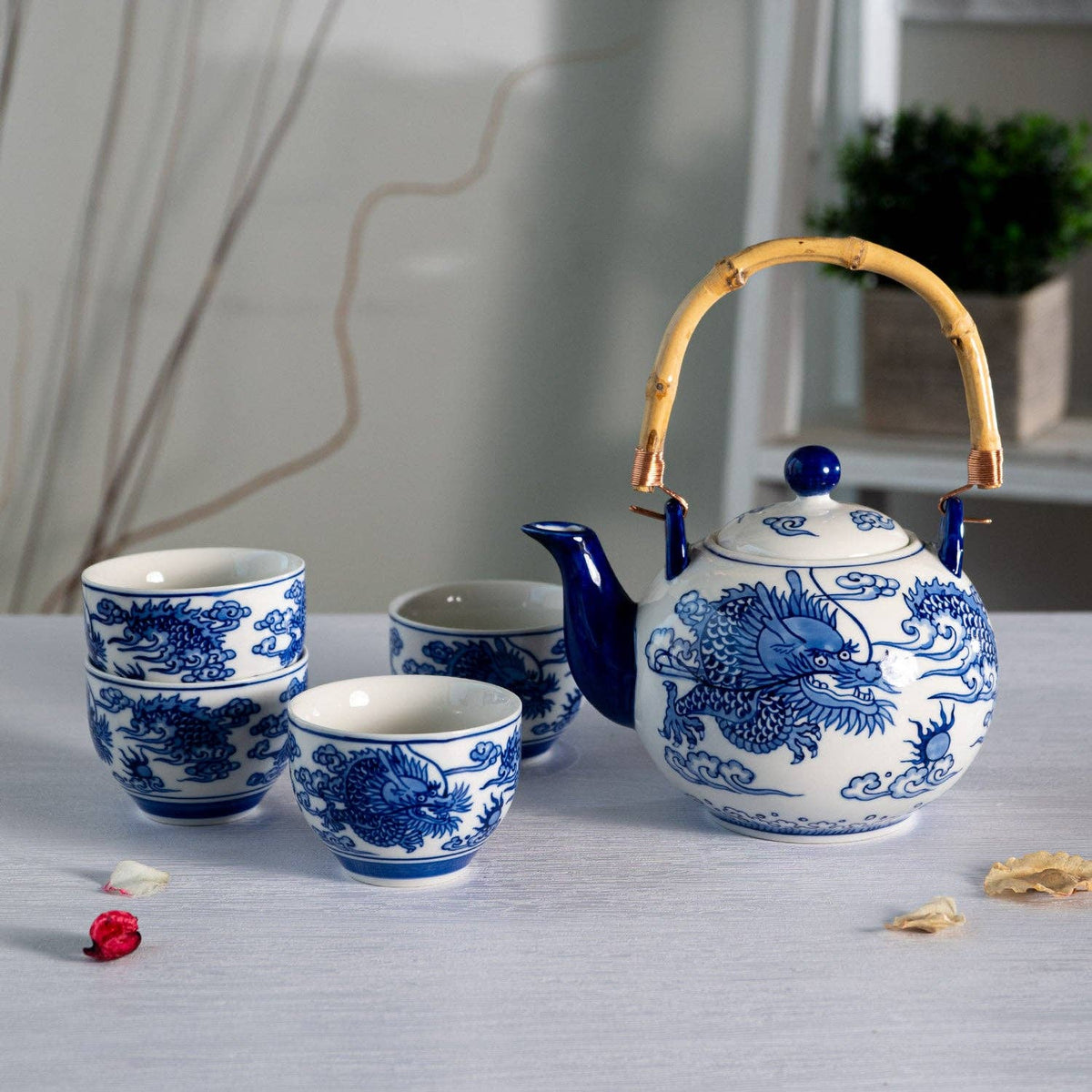 Ceramic teapot and cups with blue dragon design