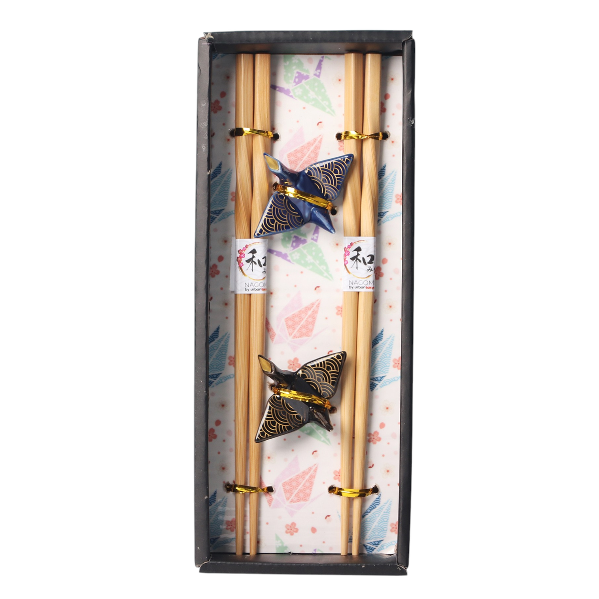 Set of chopsticks with decorative butterfly chopsticks rest in a box with a floral pattern