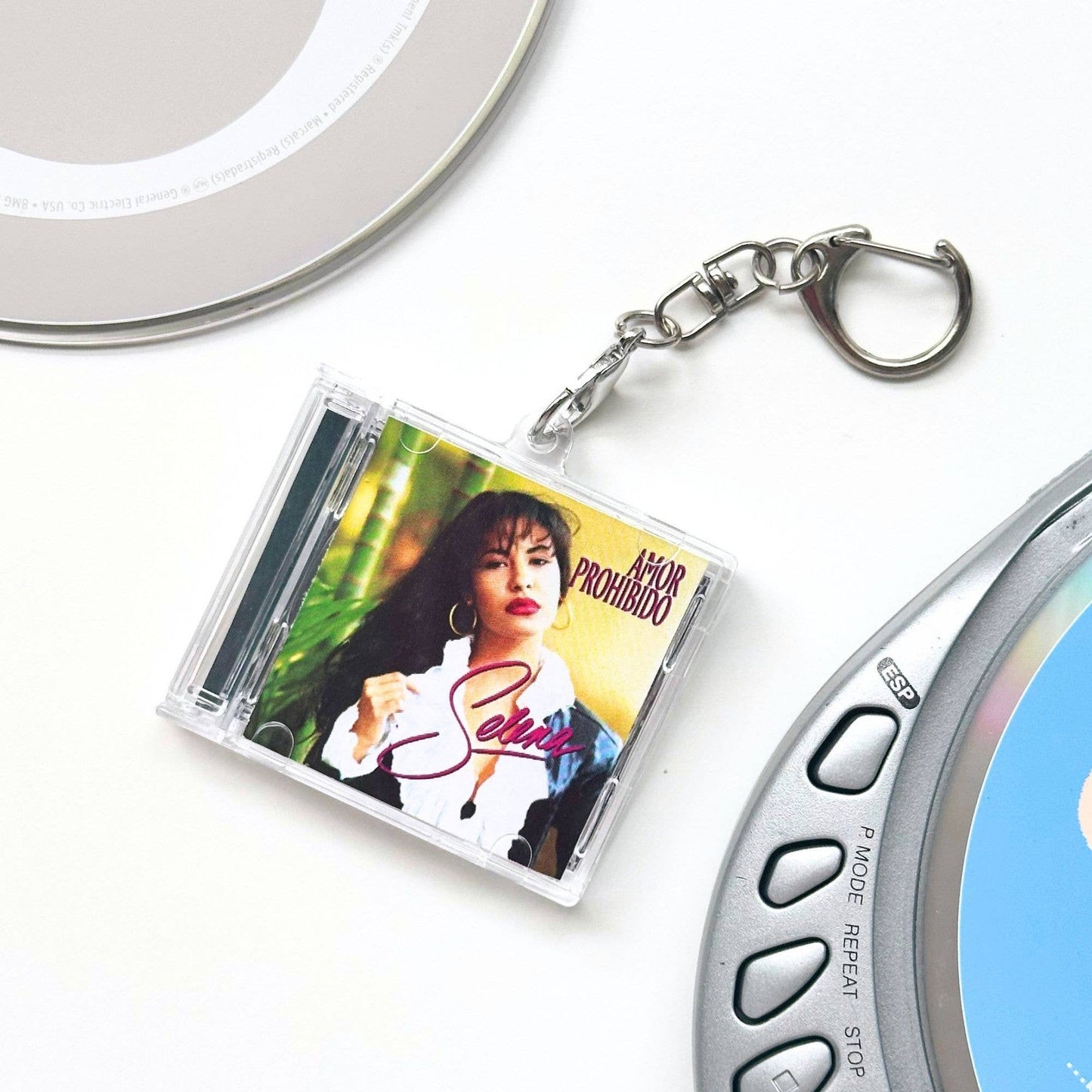 Keychain shaped like a mini CD with a music album cover featuring Selena