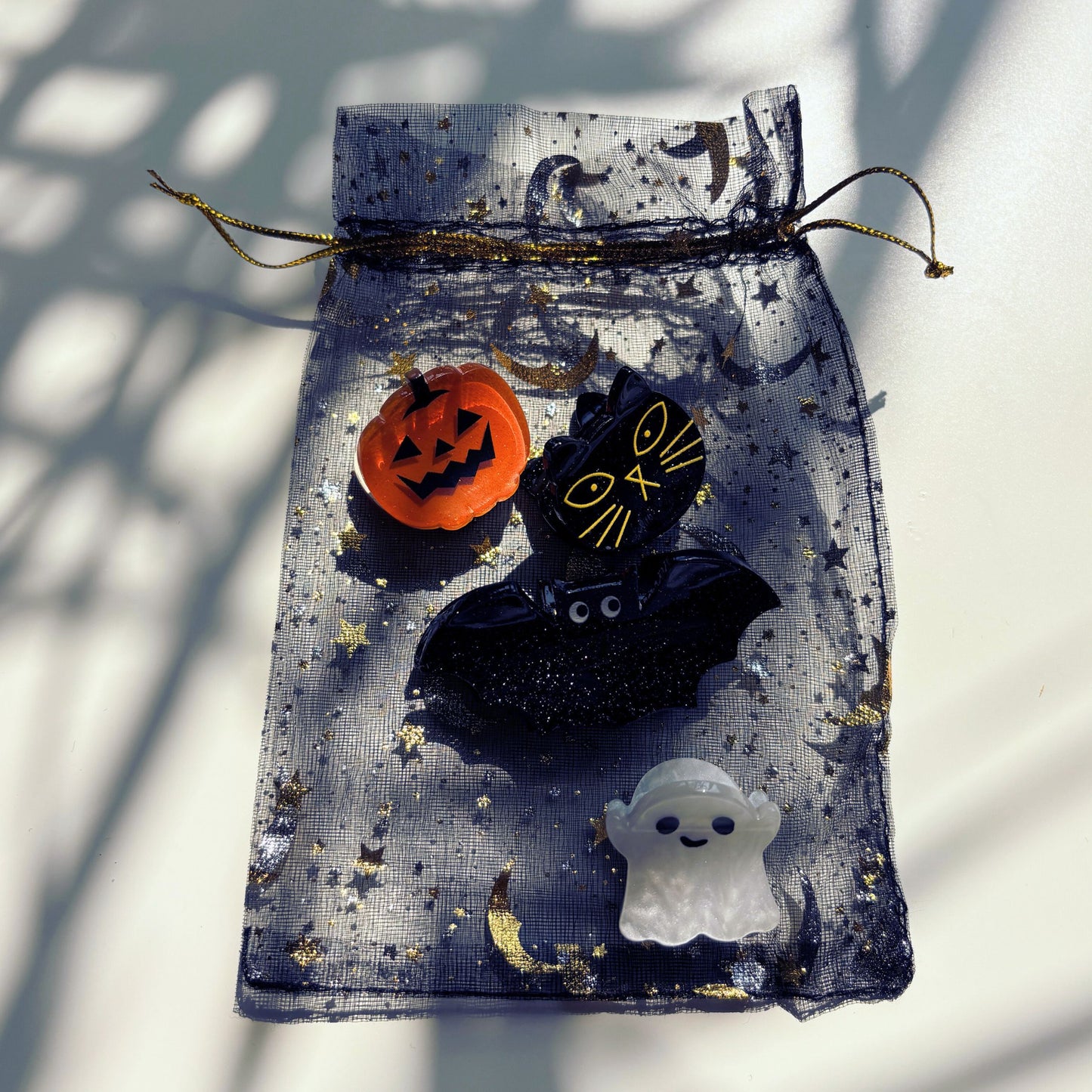 Halloween-themed decorative bag with pumpkin, witch hat, and ghost on a white background