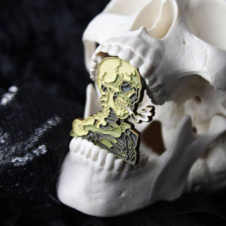 Skull of a Skeleton with Burning Cigarette Enamel Pin | Smoking Skeleton Soft Lapel Pin | 1.2" x 1"